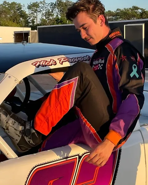 Nick Provost climbing into his car in a custom purple and black suit