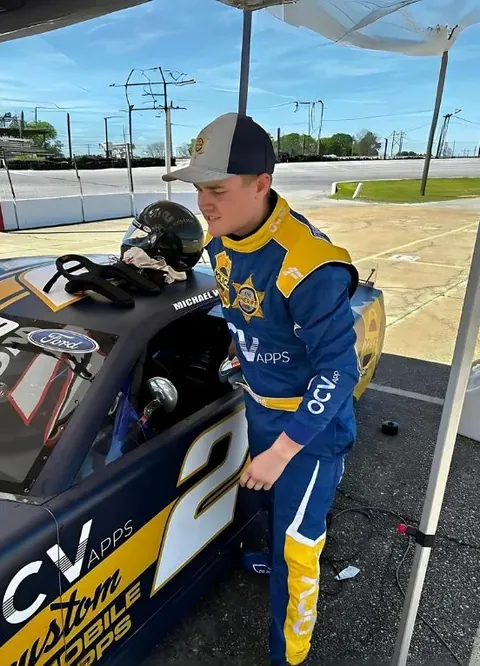 Mike Wood in his custom blue and yellow suit at his car
