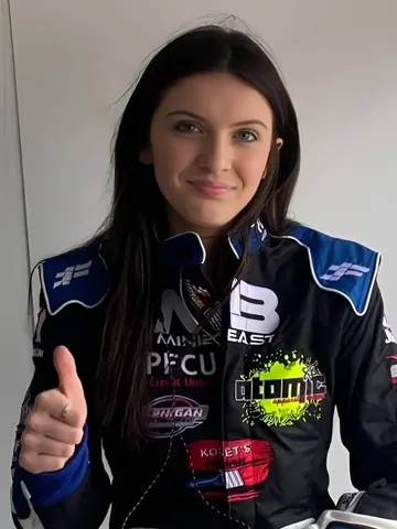 Riley Jernigan giving a thumbs up in her custom suit