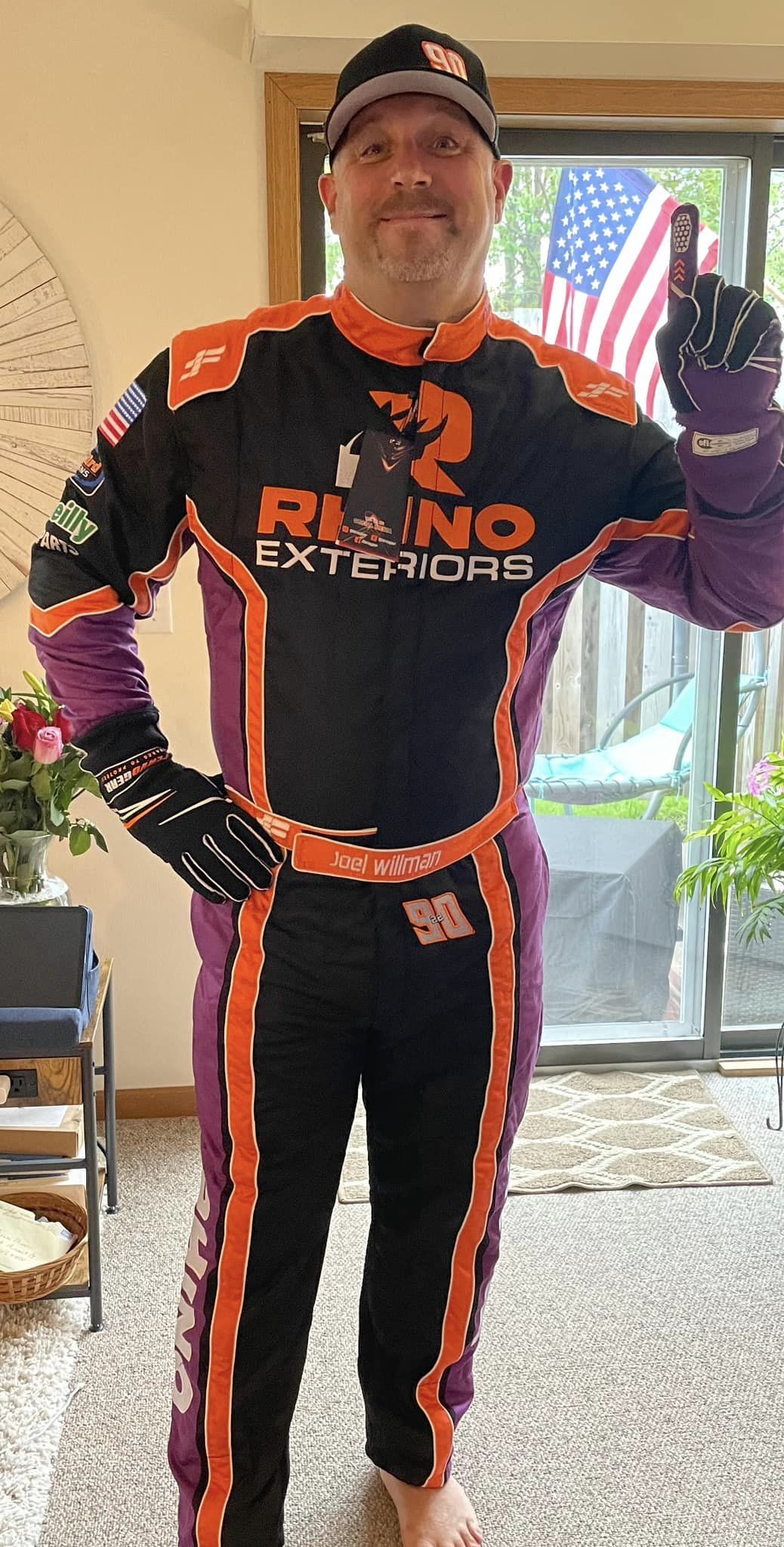Driver beside a kart in a custom FervoGear suit